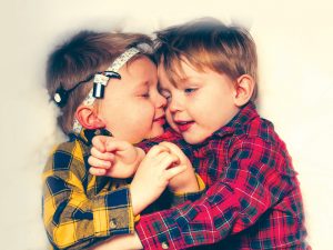 Two young brothers hugging each other